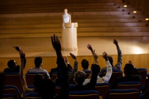 Female business executive giving a speech at conference center
